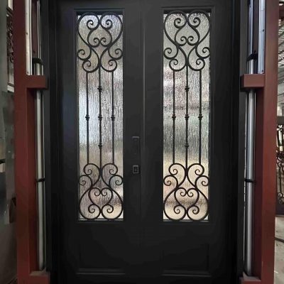 A Premium Cast Iron Spiral Staircase by Like Metal features decorative wrought iron scrollwork and frosted glass panels, set within a metal frame for an industrial look.