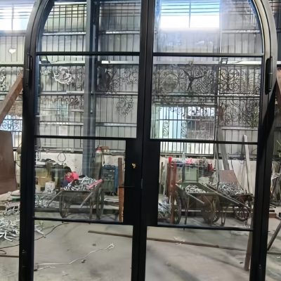 Custom wrought iron glass door with hand-forged frame and clear tempered glass panels – luxury villa entrance
