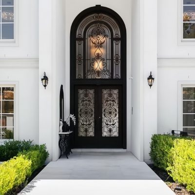 Black arched handcrafted wrought iron villa entrance door with elegant curves and premium matte finish