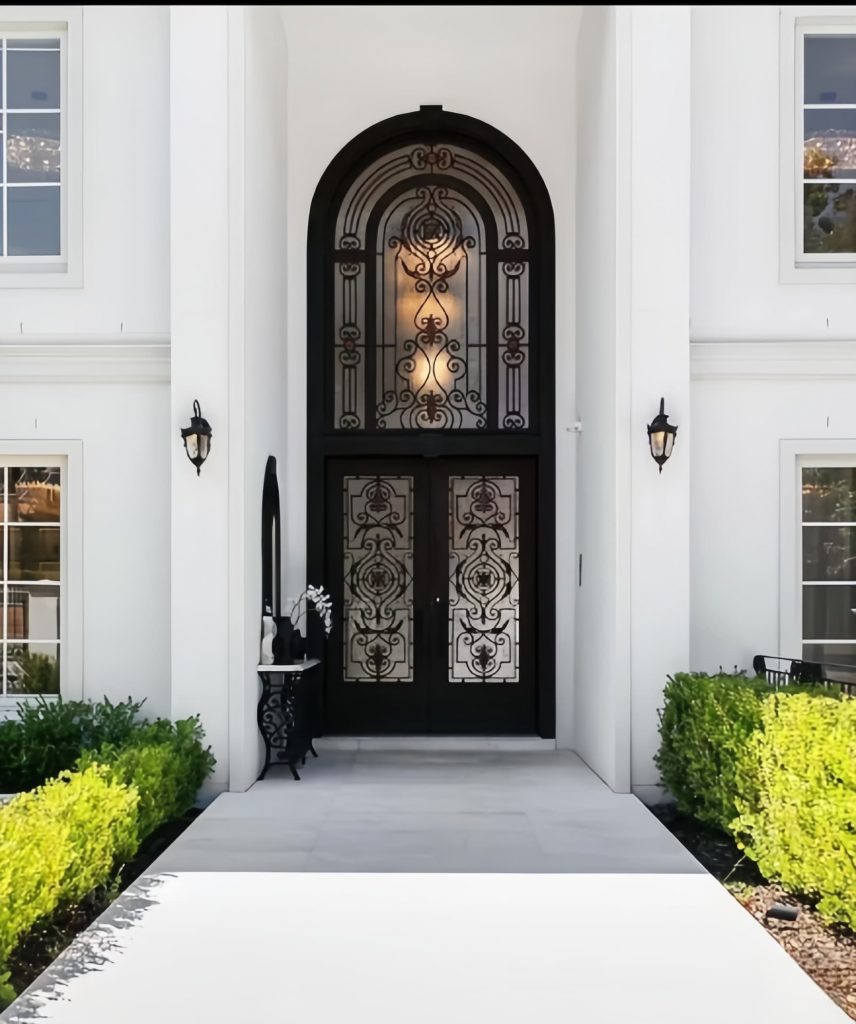 Black arched handcrafted wrought iron villa entrance door with elegant curves and premium matte finish
