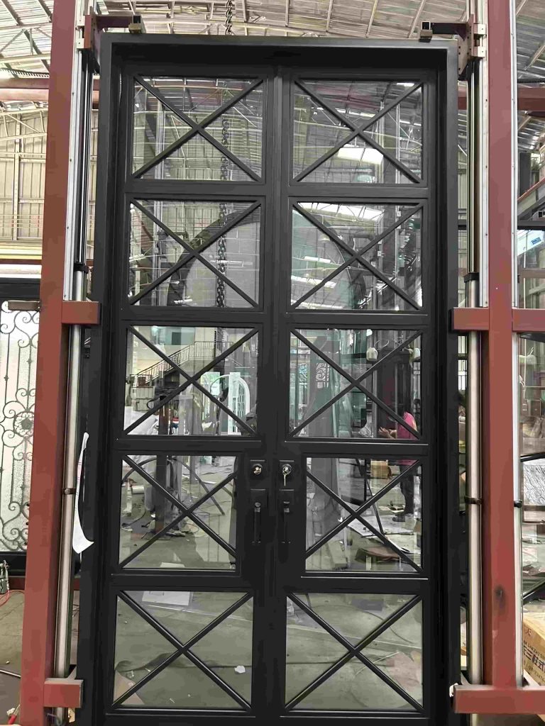 A Premium Cast Iron Spiral Staircase by Like Metal stands in a workshop filled with construction materials and metal frames.