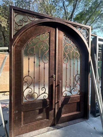 Handcrafted artistic iron gate with built-in pedestrian door for daily access without opening main leaves